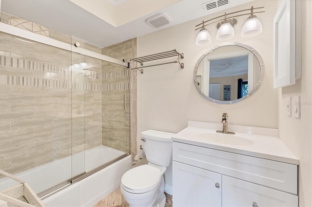 full bathroom featuring toilet, vanity, and shower / bath combination with glass door