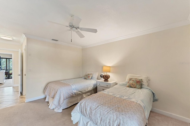 carpeted bedroom with ornamental molding and ceiling fan