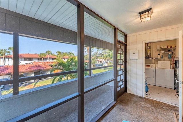 unfurnished sunroom with independent washer and dryer