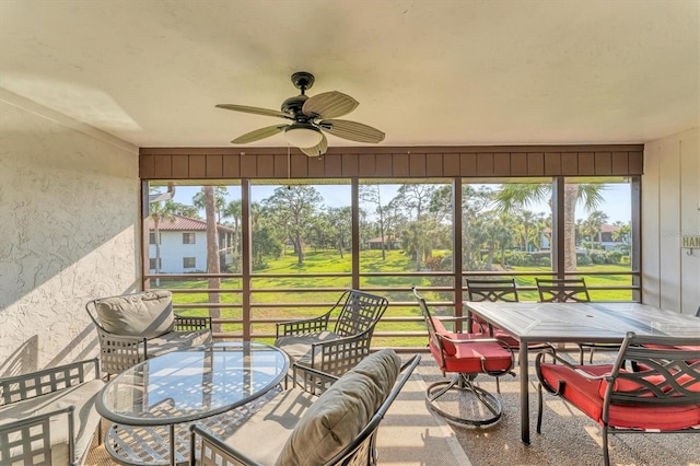 sunroom / solarium featuring ceiling fan