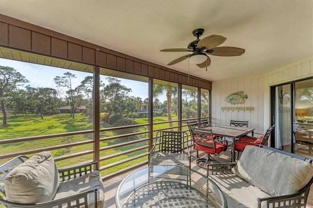 sunroom / solarium featuring ceiling fan