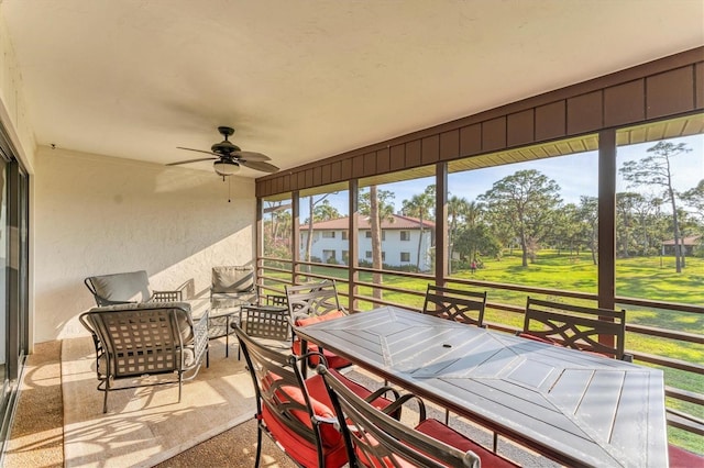 sunroom / solarium featuring ceiling fan