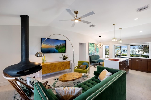 living room featuring ceiling fan and vaulted ceiling