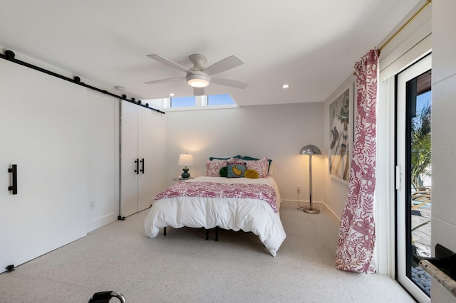 bedroom featuring ceiling fan, a barn door, and access to exterior