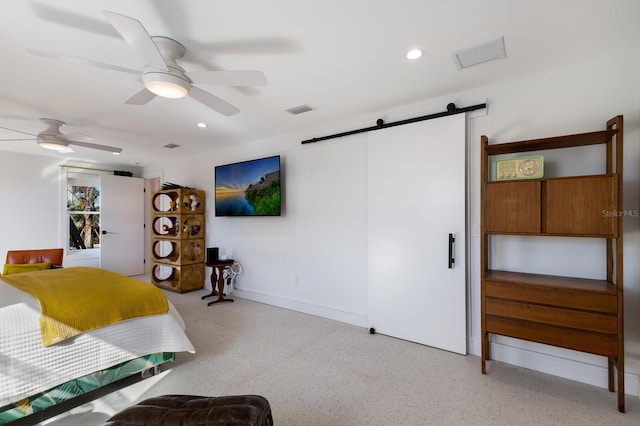 bedroom featuring a barn door and ceiling fan