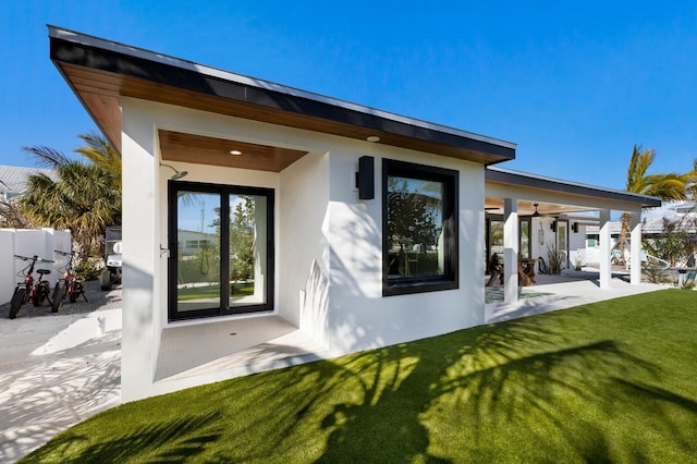 back of property with a yard and a patio area