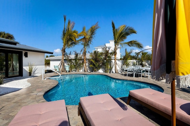 view of swimming pool featuring a patio area