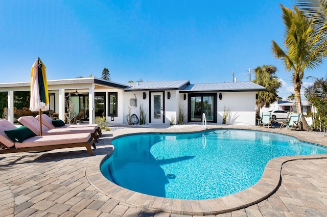 view of swimming pool featuring a patio area and ceiling fan