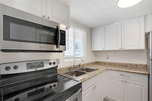 2211 Sunset Dr Unit E3, Bradenton, FL 34207 - kitchen with white cabinetry, appliances with stainless steel finishes, and sink