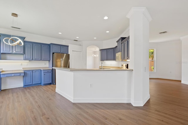 kitchen featuring stainless steel refrigerator, blue cabinets, light wood-type flooring, and pendant lighting