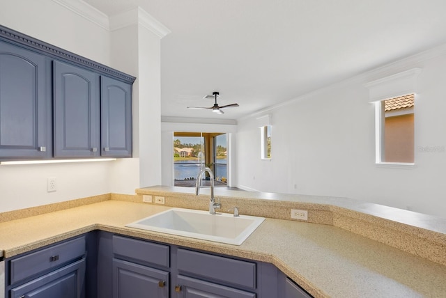 kitchen featuring sink, crown molding, blue cabinetry, and ceiling fan