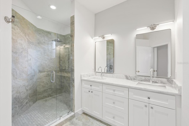 bathroom featuring vanity and a shower with door