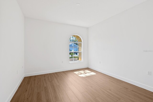 empty room with hardwood / wood-style floors