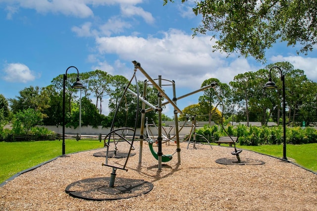 view of playground with a lawn