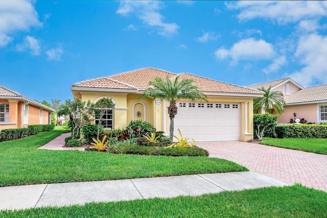 view of front of property featuring decorative driveway, a tile roof, stucco siding, a front yard, and a garage