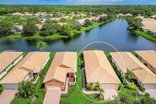 drone / aerial view with a water view and a residential view