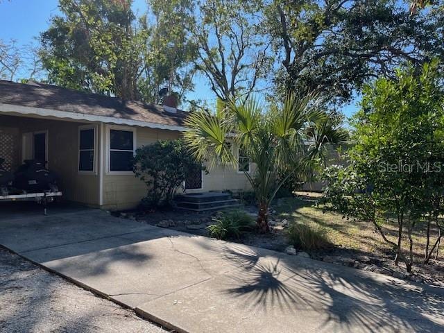 view of side of property featuring a carport