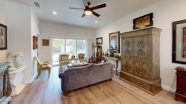 living room featuring ceiling fan and light hardwood / wood-style flooring