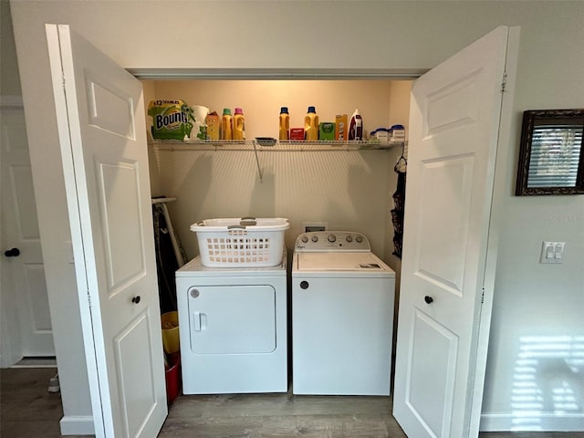 clothes washing area with hardwood / wood-style flooring and washing machine and clothes dryer