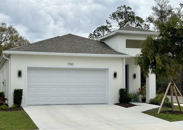 single story home featuring a garage, concrete driveway, roof with shingles, and stucco siding