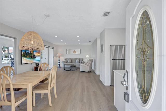 dining space featuring light wood-type flooring