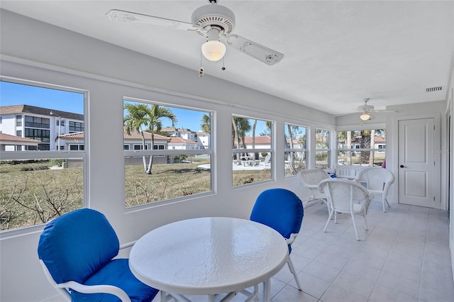 sunroom featuring ceiling fan