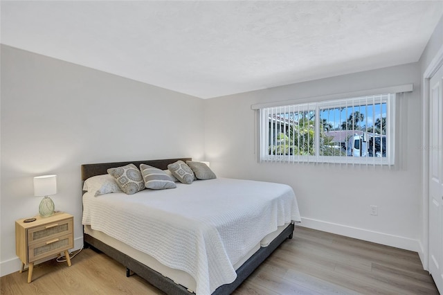 bedroom with hardwood / wood-style flooring