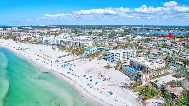 birds eye view of property featuring a beach view and a water view