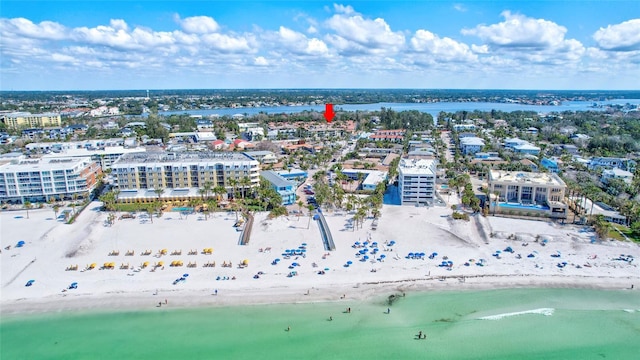 birds eye view of property with a water view and a beach view