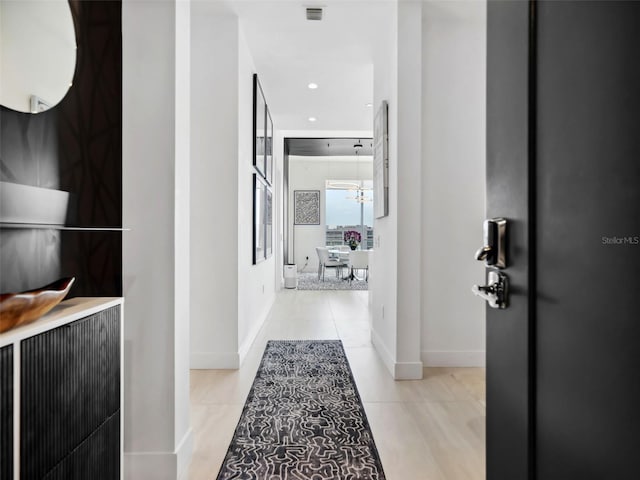 hall with light tile patterned floors