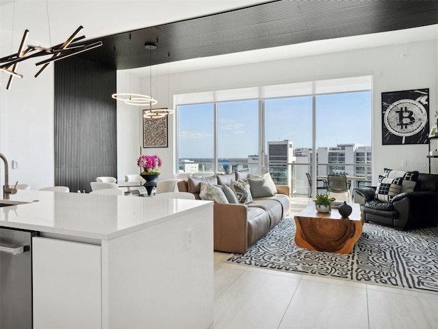 tiled living room featuring sink and plenty of natural light