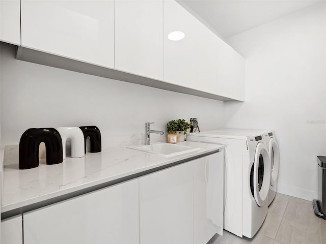 laundry area featuring sink, cabinets, and washing machine and clothes dryer