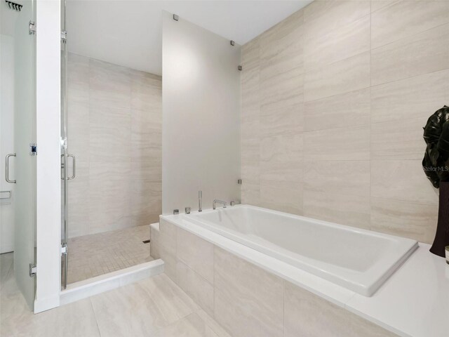 bathroom with tile patterned flooring and plus walk in shower