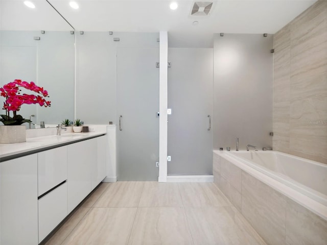 bathroom featuring vanity, independent shower and bath, and tile patterned flooring