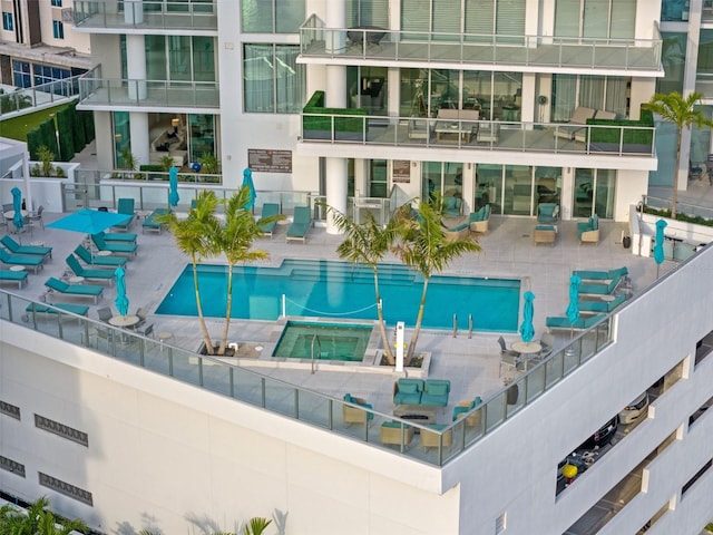 view of pool featuring a community hot tub and a patio area