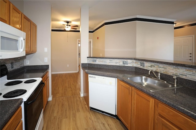 kitchen featuring crown molding, sink, white appliances, and light wood-type flooring