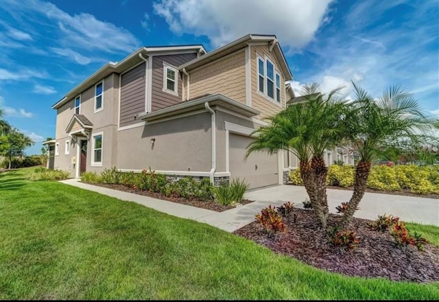 view of side of property with a yard and a garage