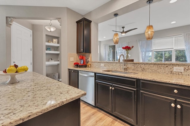 kitchen with sink, dishwasher, hanging light fixtures, dark brown cabinetry, and light stone countertops