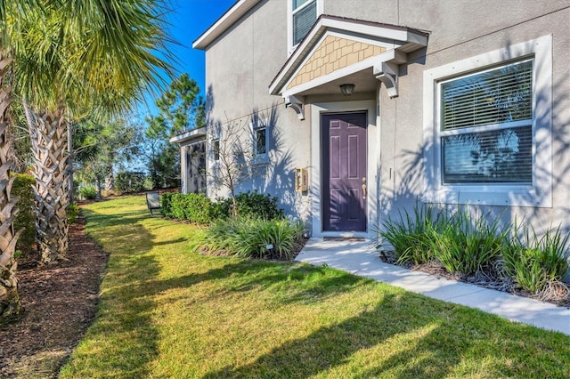 doorway to property with a yard