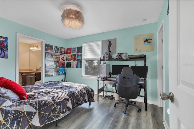 bedroom with hardwood / wood-style floors and ensuite bathroom