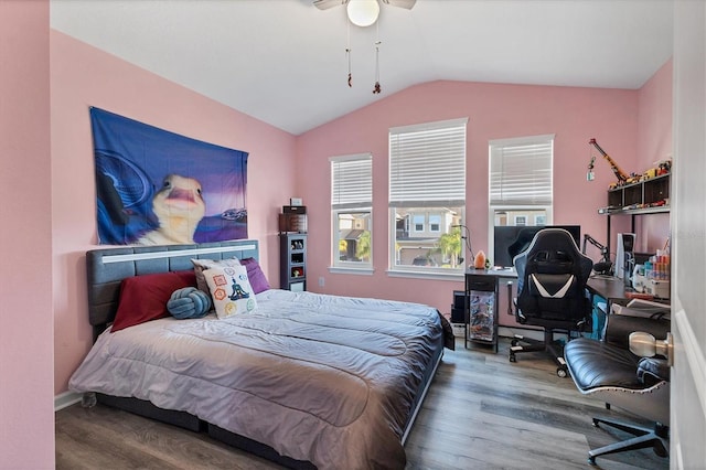 bedroom featuring hardwood / wood-style flooring, ceiling fan, and vaulted ceiling