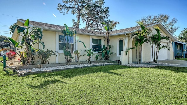 view of front of property with a garage and a front lawn