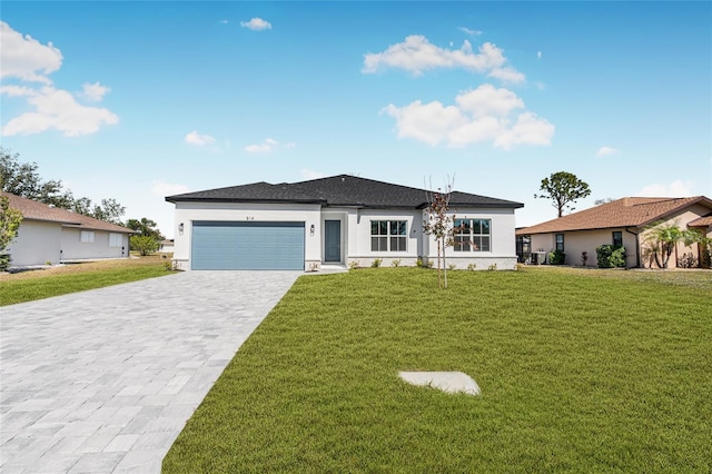 view of front of house with a garage and a front yard