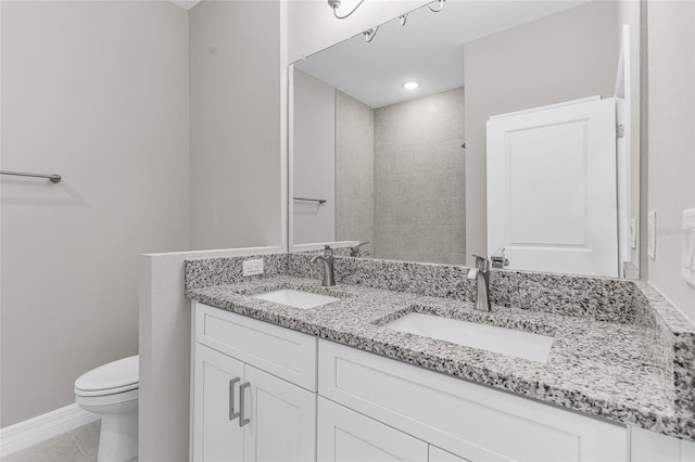 bathroom with vanity, toilet, and tile patterned flooring