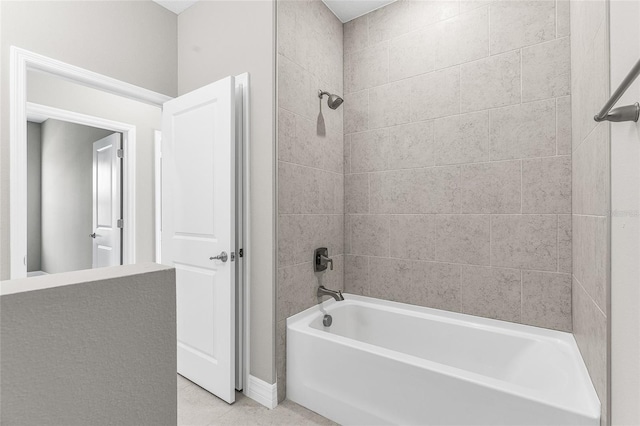 bathroom with tile patterned flooring and tiled shower / bath