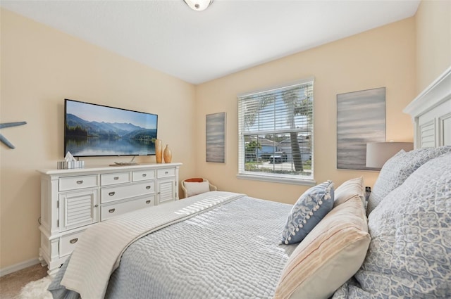 carpeted bedroom featuring baseboards