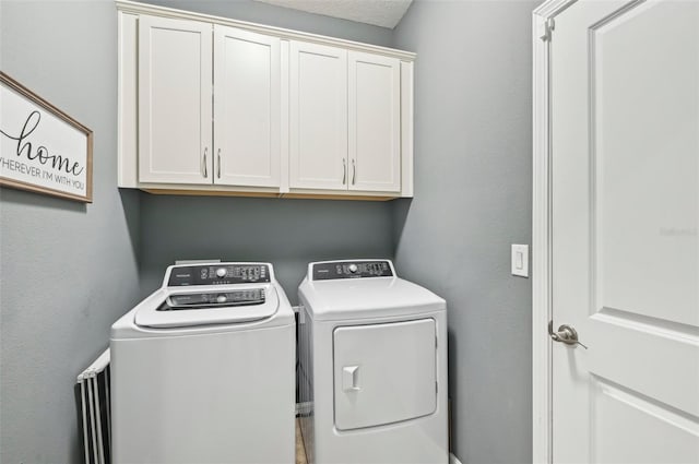 laundry room featuring cabinet space and washing machine and dryer