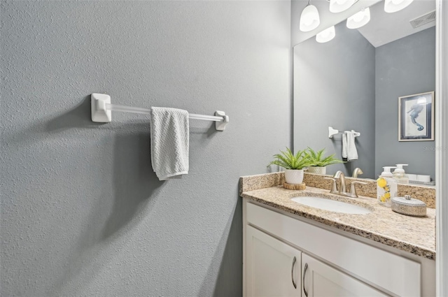 bathroom with vanity and visible vents