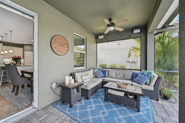 sunroom / solarium featuring a ceiling fan