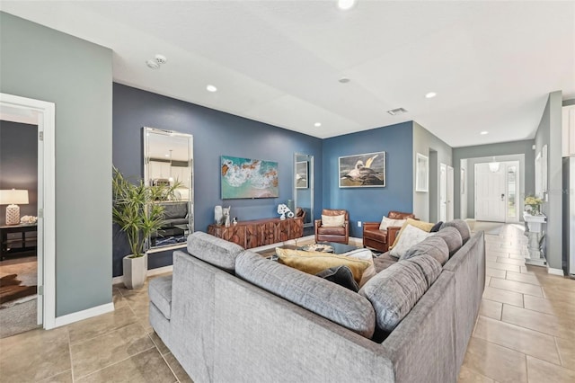 living room with light tile patterned floors, visible vents, recessed lighting, and baseboards